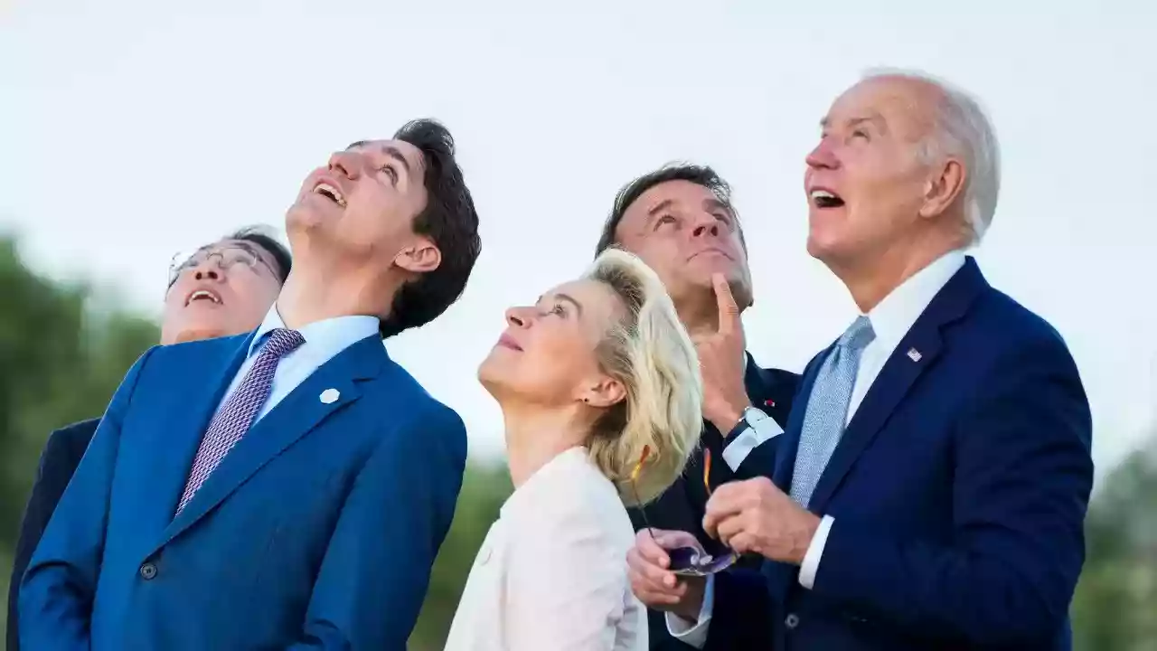 President Biden guided back by Meloni during G7 photo session