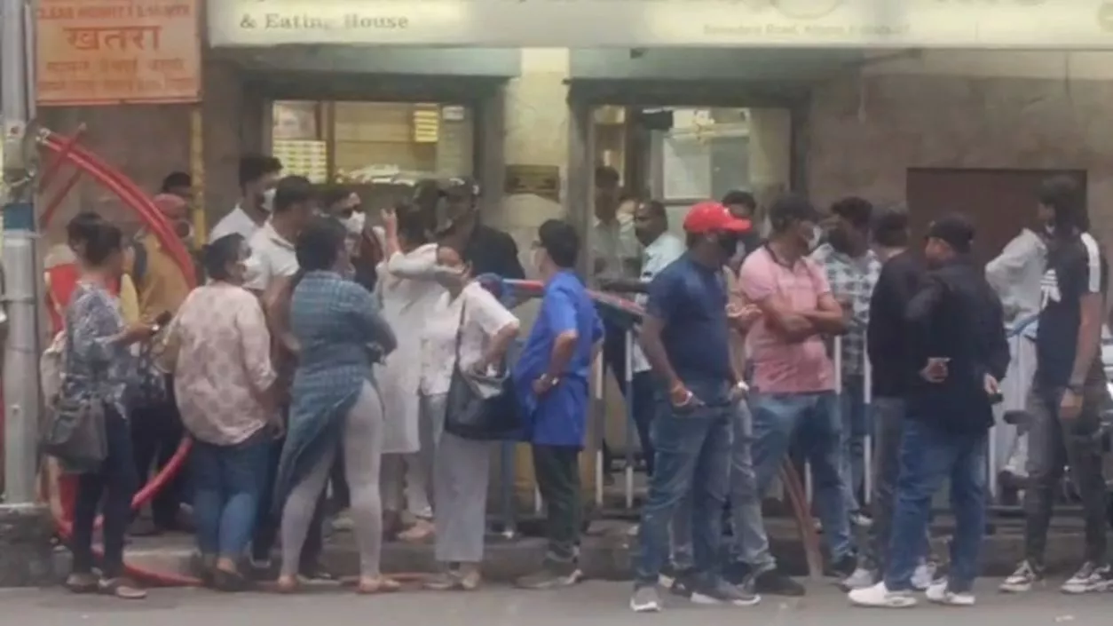 Masked protesters wait outside Bhawani Bhawan to throw eggs at Abhishek Banerjee